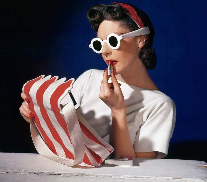 Model Muriel Maxwell putting on lipstick. American Vogue cover, 1 July 1939. Photograph: Conde Nast, Horst Estate