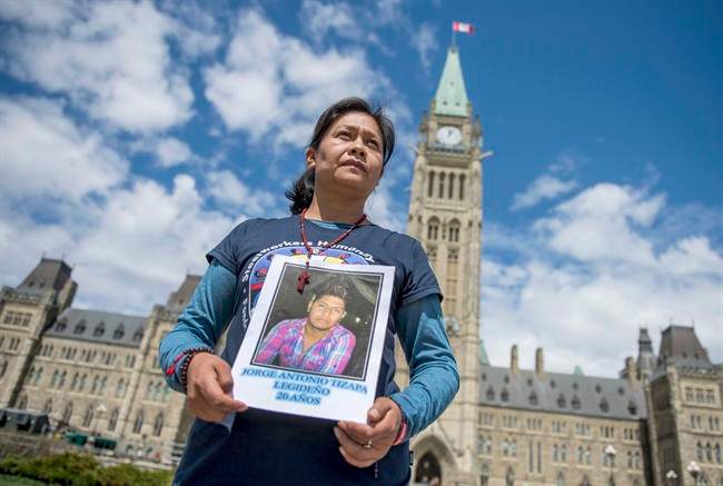 Hilda Ligideno Vargas holds a photo of her missing son, Jorge Antonio Tizapa Legideno, 20, one of 43 college students who disappeared in Mexico, on Parliament Hill in Ottawa on Friday, May 1, 2015.
