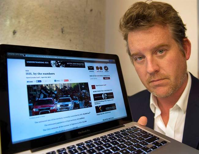 Kyle Matthews, with the Montreal Institute for Genocide and Human Rights Studies, shows some of the material used by jihadists on the internet, Friday, May 29, 2015 in Montreal. 