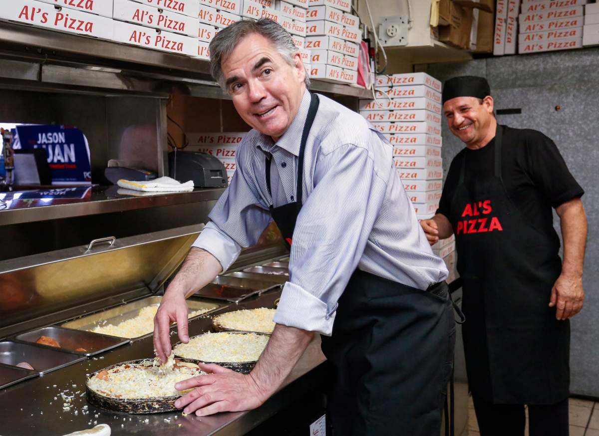 Alberta PC Party party leader Jim Prentice prepares pizza during a campaign stop at Al’s Pizza in Calgary, Alta., Wednesday, April 29, 2015.