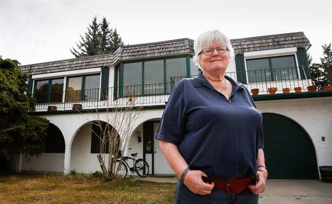 Mary Eggermont-Molenaar, standing in front of her Calgary, Alta., home on Saturday, April 18, 2015, has been told she's living in the first home of U.S. Sen. Ted Cruz by an old family friend. She'd rather not own a historical property, if it means he'd become president. 
