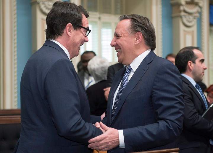Quebec Second Opposition Leader François Legault, right, greets Quebec Opposition Leader Pierre Karl Péladeau as he enters the legislature for question period Tuesday, May 19, 2015 in Quebec City.