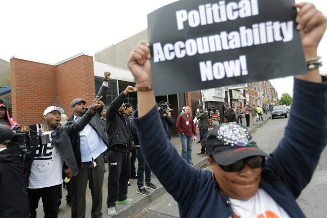 Pricilla Jackson, right, celebrates on Friday, May 1, 2015, after State's Attorney Marilyn J. Mosby announced criminal charges against all six officers suspended after Freddie Gray suffered a fatal spinal injury while in police custody in Baltimore.