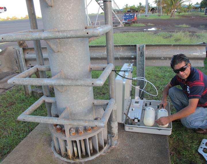 Patricio Eladio Rojas Ledezma, a Chilean meteorologist, collects air samples as part of NOAA’s Global Greenhouse Gas Monitoring Network, on Easter Island, Chile, with a portable air sampler.