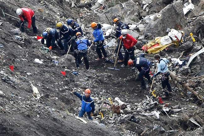 FILE - In this March 26, 2015 file photo, rescue workers work on debris of the Germanwings jet at the crash site near Seyne-les-Alpes, France.