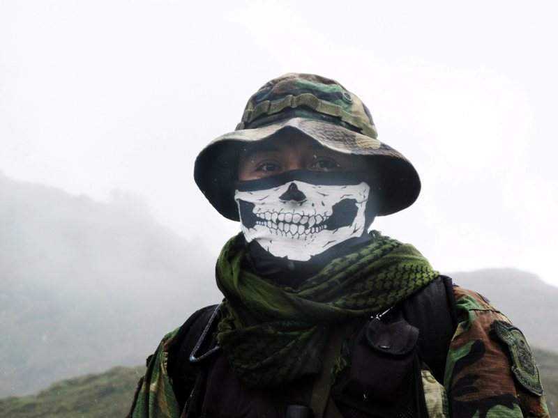 In this Feb. 28, 2015 photo, an elite policeman of the DIRANDRO counternarcotics police agency walks through a puna in Husnay, Peru, after an unsuccessful mission to try to arrest drug-toting backpackers hiking up from the world’s No. 1 cocaine-producing region. 