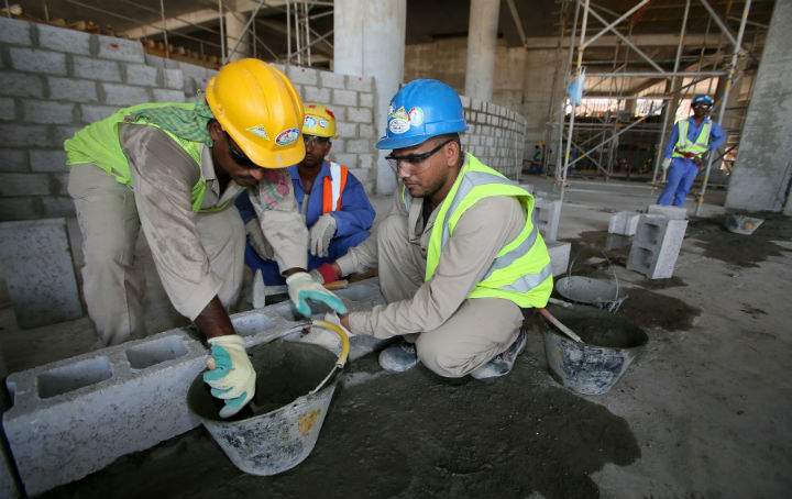 Migrant labourers work on a construction site on October 3, 2013 in Doha in Qatar. Qatar, the 2022 World Cup host is under fire over claims of using forced labour.