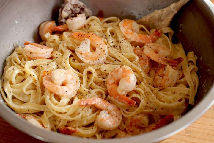 This April 6, 2015 photo shows pepper-scampi Alfredo in Concord, N.H. In this recipe, chopped, cooked chicken breasts, crispy hunks of bacon or strips of smoked salmon can be substituted for the shrimp.