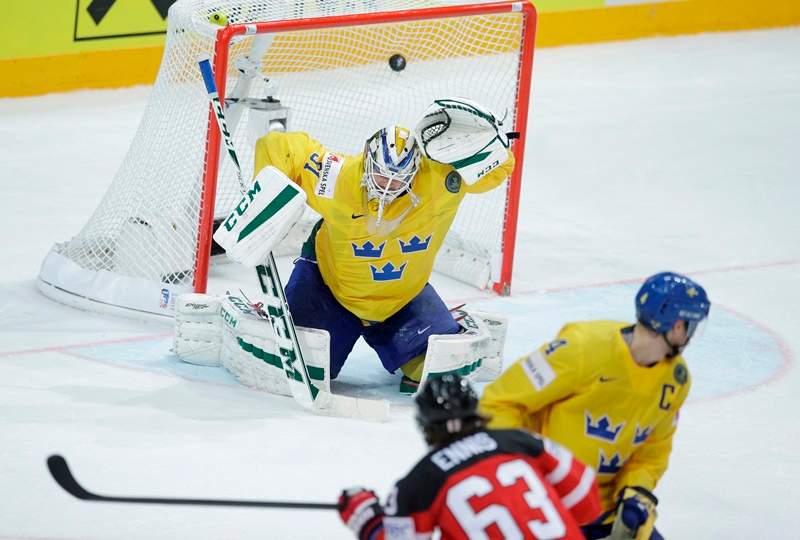Sweden’s goalkeeper Anders Nilsson, top, fails to stop a shot by Canada’s Tyler Ennis, bottom, during the Hockey World Championships Group A match in Prague, Czech Republic, Wednesday, May 6, 2015.