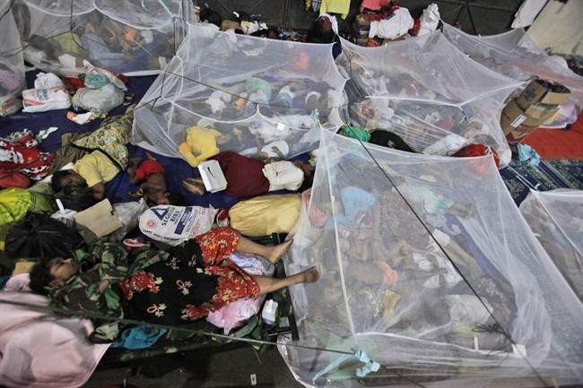 Ethnic Rohingya women and children sleep under mosquito net at a temporary shelter in Langsa, Aceh province, Indonesia, Sunday, May 17, 2015.