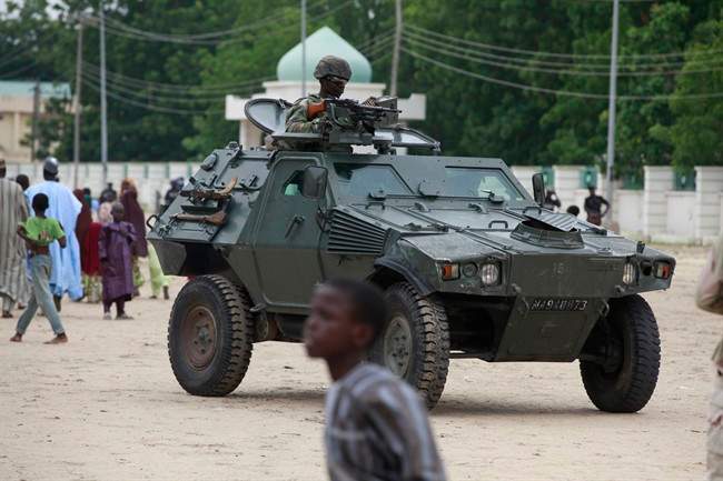 Nigerian soldiers ride on an armored personnel carrier during Eid al-Fitr celebrations in Maiduguri, Nigeria. 