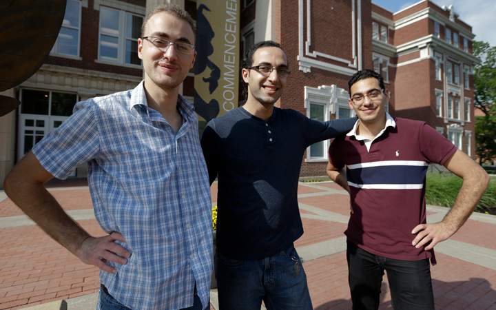 Syrian brothers Mohammad Kayali, left, Ebrahim Kayali, right and Molham Kayali, center, pose for a photograph on the Emporia State University campus in Emporia, Kan., Wednesday, May 6, 2015.  