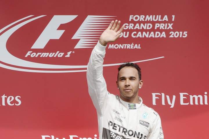 Mercedes driver Lewis Hamilton of Great Britain waves to the crowd as he celebrates after winning the Canadian Grand Prix in Montreal on Sunday, June 7, 2015.