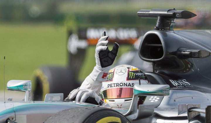Lewis Hamilton from Great Britain salutes the crowd after winning the Canadian Grand Prix in Montreal, Sunday, June 7, 2015.