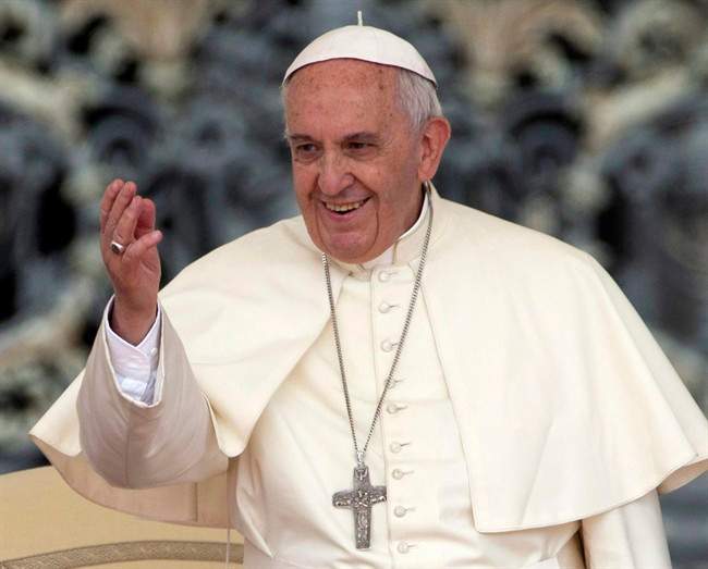 Pope Francis waves to faithful during his weekly general audience, in St. Peter's Square, at the Vatican.