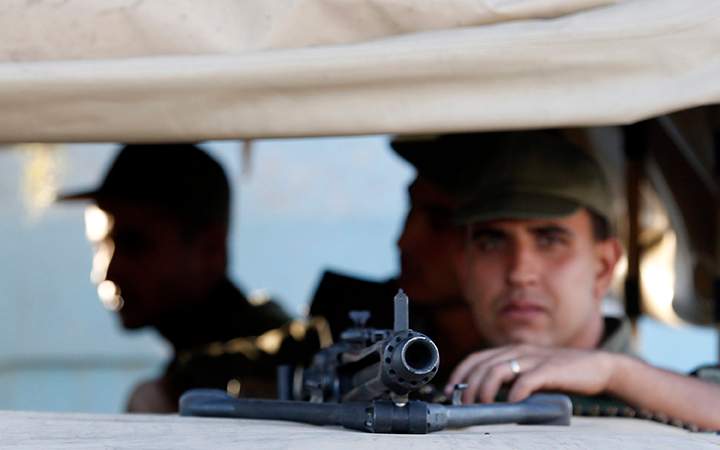 Tunisian army soldiers guard the street near the attacked Imperial Marhaba hotel in Sousse, Tunisia, Saturday, June 27, 2015. 