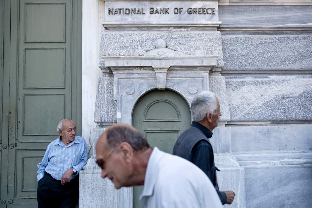 Elderly people wait to receive their pension outside the National bank of Greece headquarters in Athens, Monday, June 29, 2015. (AP Photo/Petros Giannakouris)