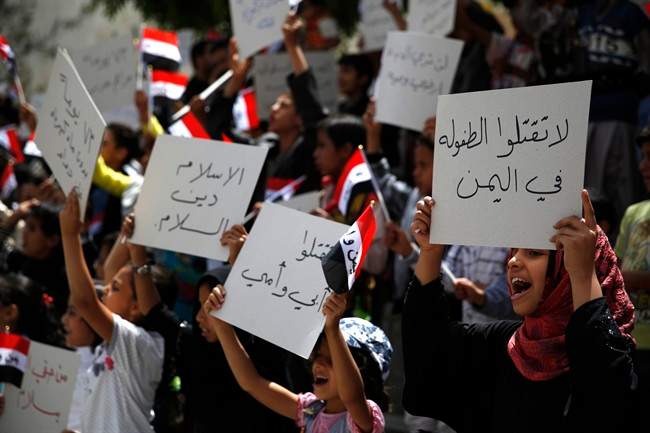 Yemeni children chant slogans during a protest against Saudi-led airstrikes, in Sanaa, Yemen, Saturday, June 6, 2015. 
