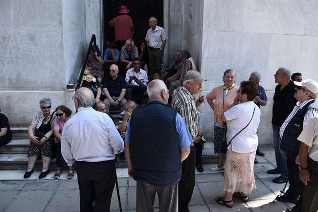 Anxious Greek pensioners swarmed bank branches hoping to be able to receive their pensions Monday and others lined up at ATMs as they gradually began dispensing cash again on the first day of capital controls imposed in a dramatic twist in Greeces five-year financial saga.
