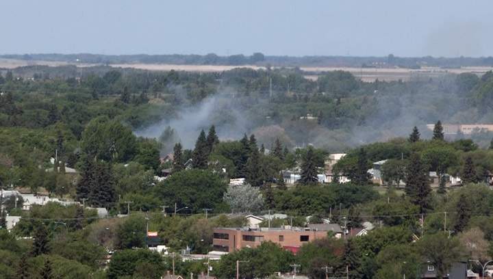 Smoke rises from a fire at 230 Avenue R North in Saskatoon on Friday, June 5, 2015.