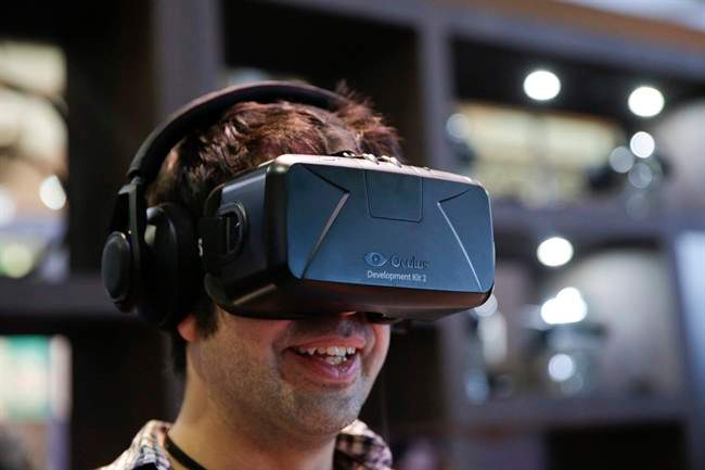  In this June 11, 2014 file photo, a man tries out the Oculus Rift virtual reality headset at the Oculus booth at the Electronic Entertainment Expo, in Los Angeles. 
