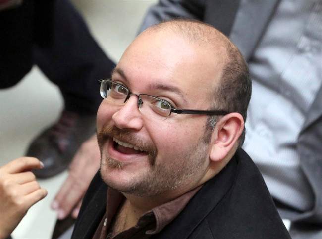 FILE - In this photo April 11, 2013 file photo, Jason Rezaian, an Iranian-American correspondent for The Washington Post, smiles as he attends a presidential campaign of President Hassan Rouhani in Tehran, Iran. Iran's official IRNA news agency says the detained Washington Post correspondent is back in court on Monday, June 8, 2015 for the second closed-door hearing in his espionage trial.(AP Photo/Vahid Salemi, File).