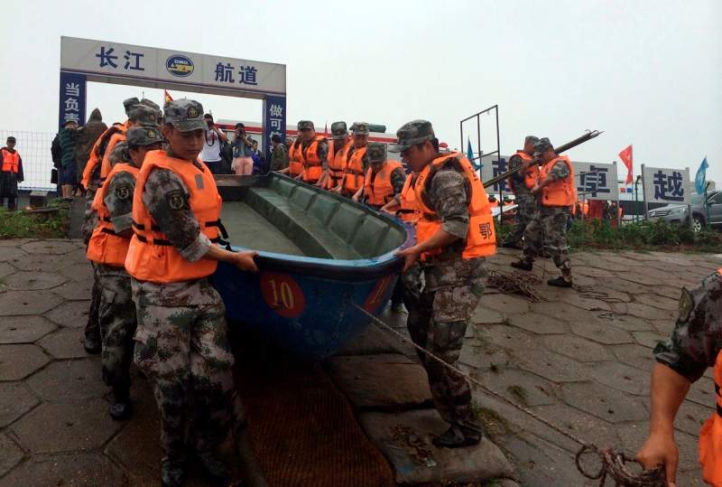 Rescue workers prepare to head out on boats on the Yangtze River to search for missing passengers after a ship capsized in central China’s Hubei province Tuesday, June 2, 2015.