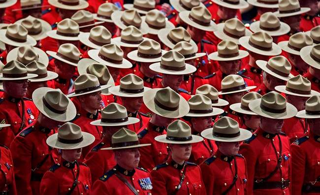A moment of silence is observed at the regimental funeral for three RCMP officers who were killed on duty, at the Moncton Coliseum in Moncton, N.B. on Tuesday, June 10, 2014.