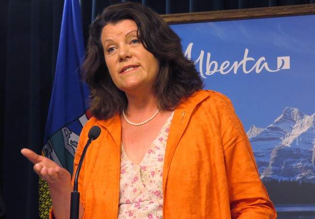Alberta Jobs Minister Lori Sigurdson announces at the legislature in Edmotnon, Monday, June 29, 2015 that the minimum wage is rising by $1 to $11.20 an hour on Oct. 1, making it one of the highest wage rates in Canada. Alberta is also phasing out by 2016 the lower rate minimum wage paid to liquor servers. 