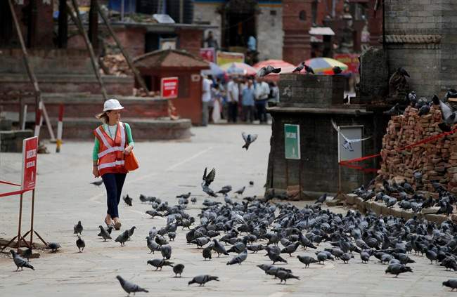 A foreign delegate walks at the Basantapur Durbar Square heritage site in Kathmandu, Nepal, Wednesday, June 24, 2015.