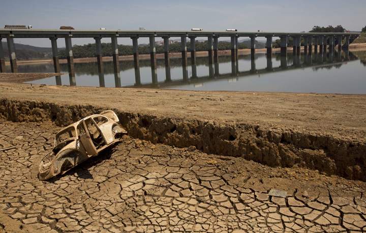 The frame of a car sits on the cracked earth at the bottom of the Atibainha dam, part of the Cantareira System responsible for providing water to the Sao Paulo metropolitan area, in Nazare Paulista, Brazil. 