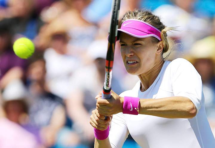 Eugenie Bouchard returns the ball to Belinda Bencic during day five of the women's international tennis tournament at Devonshire Park, Eastbourne, England, Wednesday June 24, 2015. 
