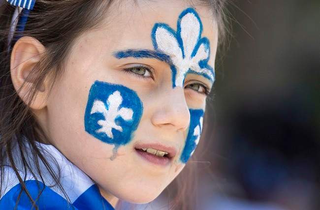 A young girl watches the annual St-Jean-Baptiste Day parade in this file photo.