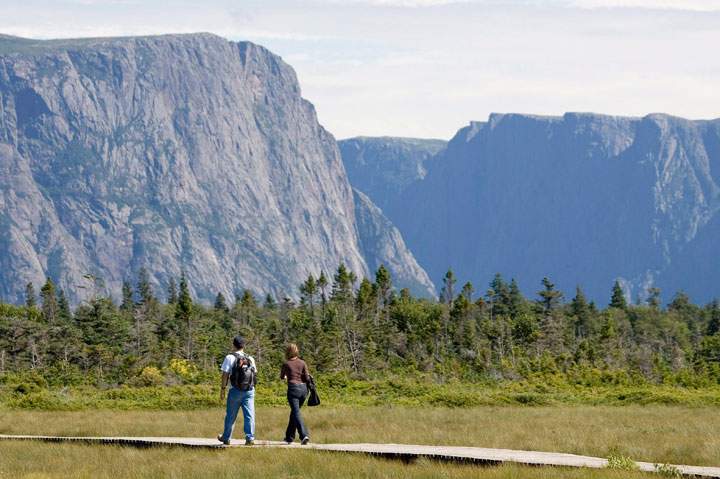 A couple walk along a boardwalk on their way to Western Brook Pond in Gros Morne, N.L., on August 14, 2007. Gros Morne, with its glacier-carved fjords, waterfalls, sandy beaches and spectacular cliffs, is a hiker's paradise that was designated a UNESCO world heritage site in 1987.