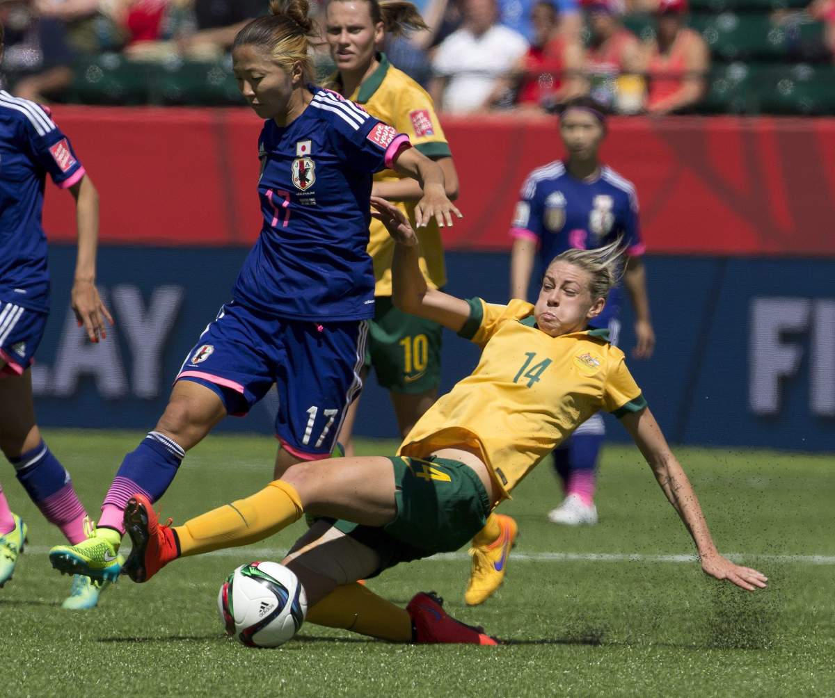 Japan’s Yuki Ogimi (17) and Australia’s Alanna Kennedy (14) battle for the ball during second half FIFA Women’s World Cup quarter-final action in Edmonton, Alta., on Saturday June 27, 2015.