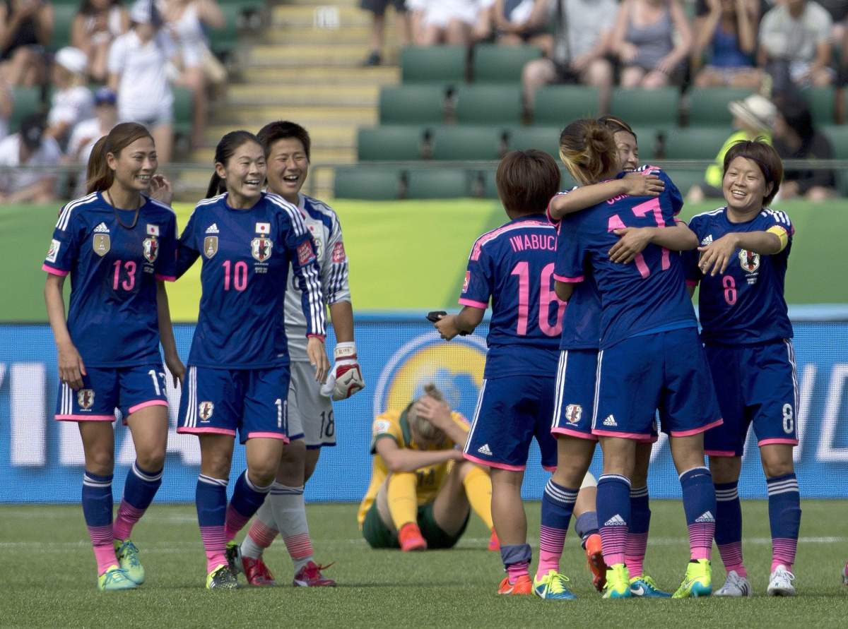Japan celebrates their win as Australia’s Alanna Kennedy (14) reacts during FIFA Women’s World Cup quarter-final action in Edmonton, Alberta, Canada, Saturday June 27, 2015.