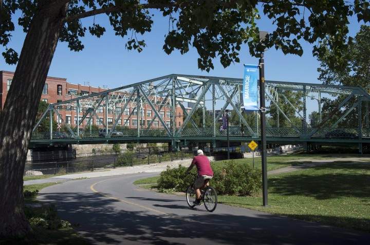 A cyclist ride his bike along the Lachine Canal in Montreal.