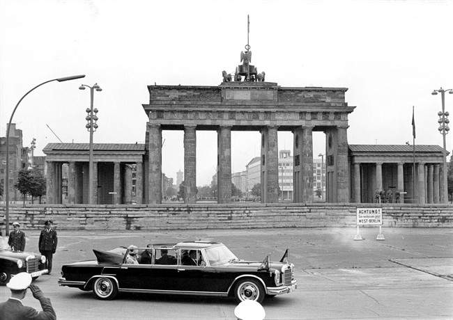 A May 27, 1965 file photo of Britain’s Queen Elizabeth II and Prince Philip being driven in a Mercedes 600 car as they pass the Brandenburg Gate during their first visit to Berlin.