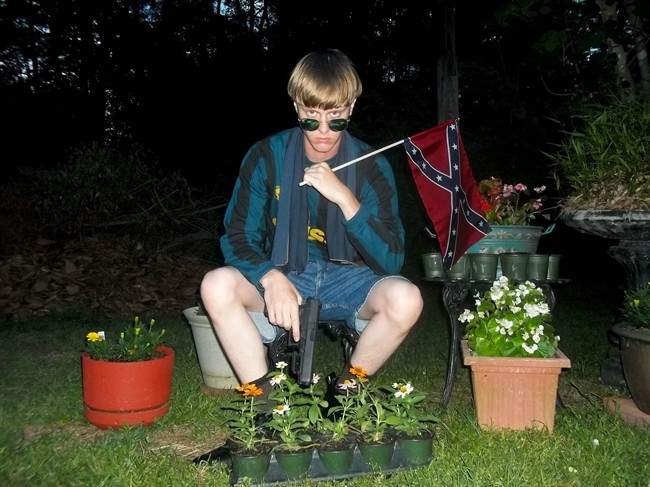 This undated image that appeared on Lastrhodesian.com, a website being investigated by the FBI in connection with Charleston, S.C., shooting suspect Dylann Roof, shows Roof posing for a photo while holding a Confederate flag.