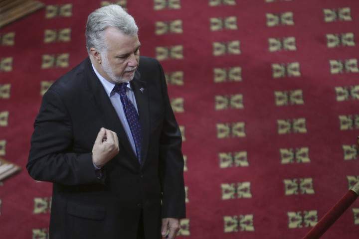 Quebec Premier Philippe Couillard pays respect to former Quebec premier Jacques Parizeau who lies in state at the National Assembly in Quebec City on Sunday, June 7, 2015.