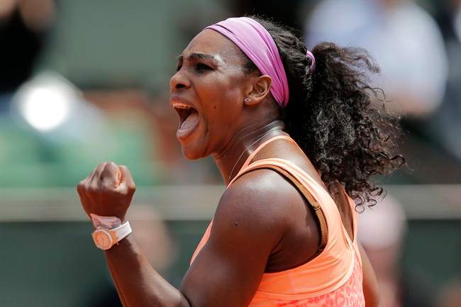 Serena Williams of the U.S. clenches her fist after scoring a point in the quarterfinal match of the French Open tennis tournament against Italy's Sara Errani at the Roland Garros stadium, in Paris, France, Wednesday, June 3, 2015.