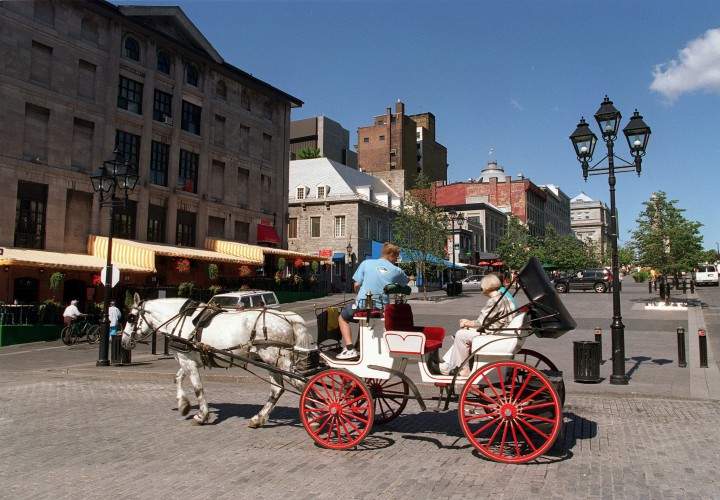 A horse-draw carriage in front of Place Jacques Cartier in Old Montreal.