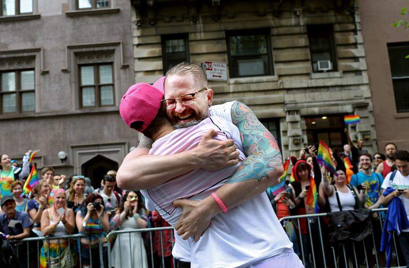 Erik Sudduth hugs Sam Branman after proposing to him during the Gay Pride Parade on June 28, 2015 in New York City.