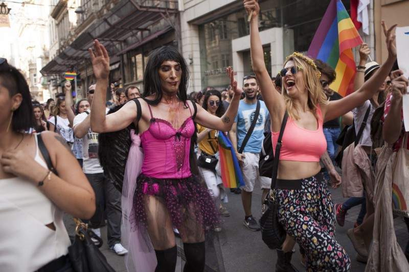 Gay pride supporters wave flags before Istanbul police used water cannons, rubber bullets as well as tear gas on pride paraders in Turkey’s 13th annual gay parade.