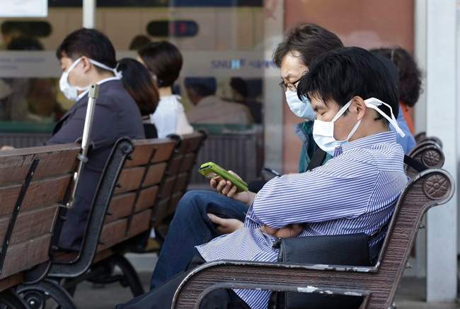 South Koreans wearing masks as a precaution against the Middle East Respiratory Syndrome virus sit at an emergency room at Seoul National University Hospital in Seoul, South Korea Monday, June 1, 2015. More than 680 people in South Korea are isolated after having contact with patients infected with a virus that has killed hundreds of people in the Middle East, health officials said Monday. (AP Photo/Ahn Young-joon).