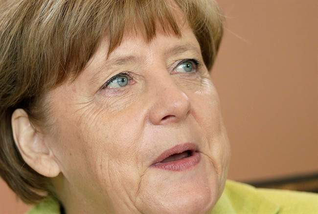 German Chancellor Angela Merkel speaks as she arrives for the weekly cabinet meeting at the chancellery in Berlin, Germany, Wednesday, June 17, 2015.