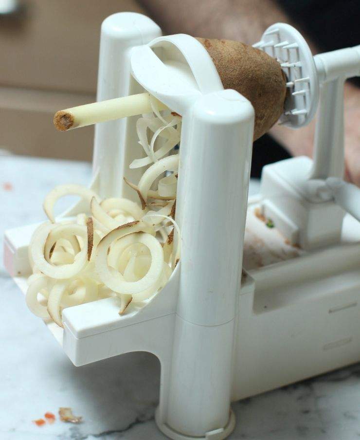 This Jan. 12, 2015 photo shows the preparation of baked garlic thyme curly fries in Concord, N.H. This dish is from a recipe by Melissa d’Arabian. (AP Photo/Matthew Mead)