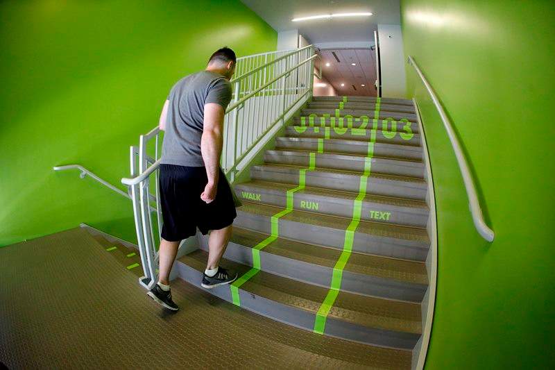 In this file photo a Utah Valley University student walks up the stairs to the gym.