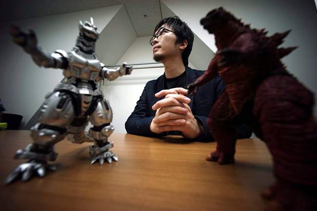 In this May 20, 2015 photo, Shunsuke Fujita, Godzilla video game's producer of Bandai Namco Entertainment, speaks on new Godzilla game for the Sony Corp. PlayStation 4 home machine in Tokyo. 