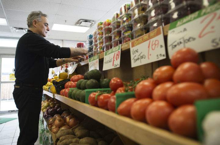 Azmi Farah, a Hasty Market owner, organizes produce at his Hasty Market location in Toronto on Wednesday, April 22, 2015.  (File photo).